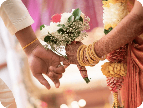 Indian wedding image in which the groom holds the bride's hand