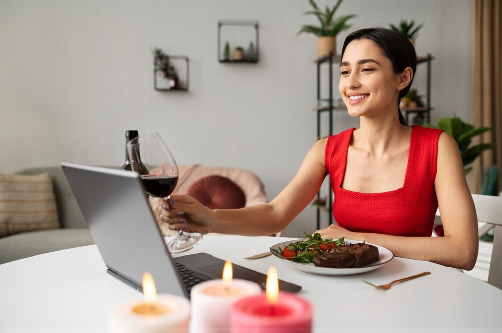 A girl with a laptop and having dinner