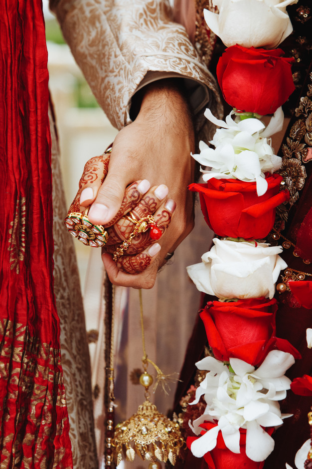 authentic-indian-bride-groom-s-hands-holding-together-traditional-wedding-attire_8353-10049